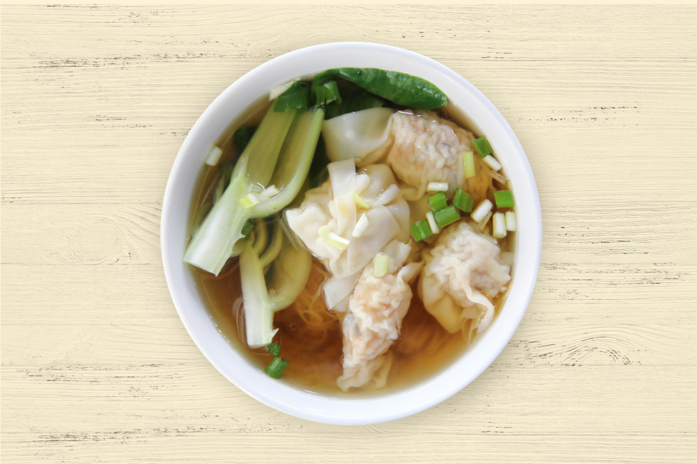 Bowl of dumpling soup with bok choy